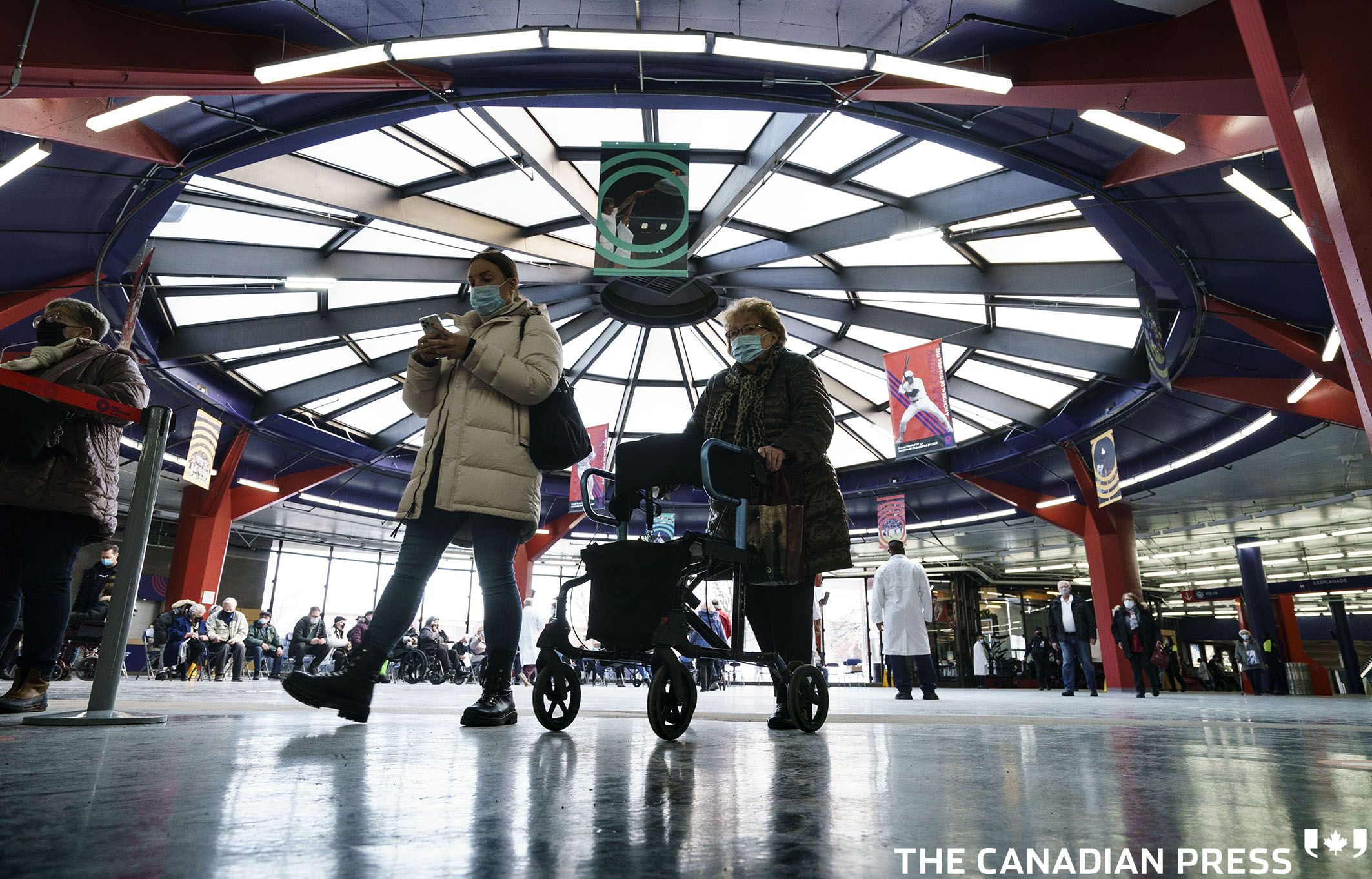 Seniors arrive for their COVID-19 vaccination at a clinic in Olympic Stadium in Montreal, on Wednesday, March 3, 2021. THE CANADIAN PRESS/Paul Chiasson