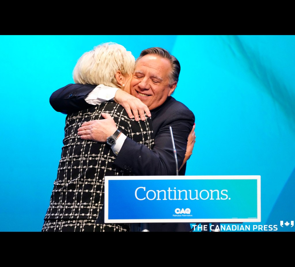 CAQ Leader Francois Legault hugs and kisses his wife Isabelle Brais as he makes his victory speech to supporters at the Coalition Avenir Quebec election night headquarters in Quebec City, Monday, Oct. 3, 2022. THE CANADIAN PRESS/Paul Chiasson